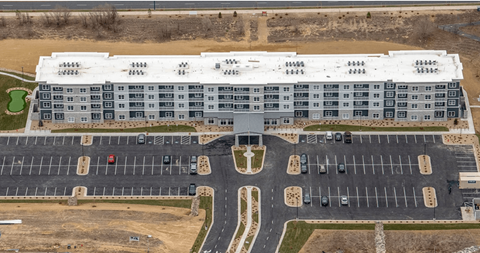 A large building with a parking lot in front of it.