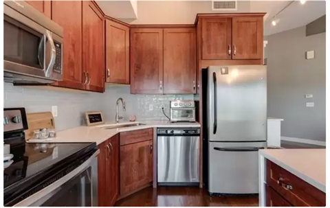 A kitchen with wooden cabinets and stainless steel appliances.