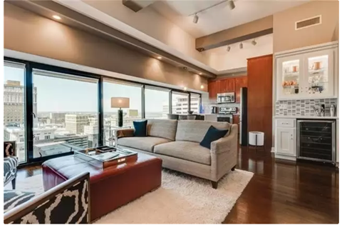 A modern living room with a large window overlooking the city.