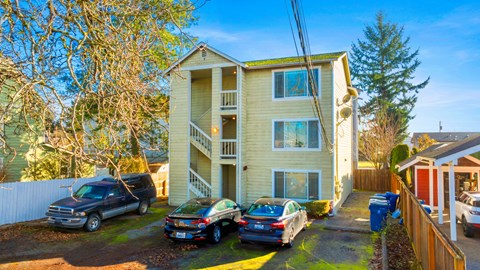 A two-story house with a carport and a garage.