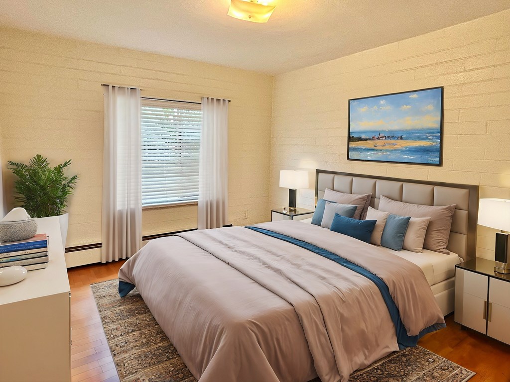 A bedroom with a large bed and a painting on the wall.