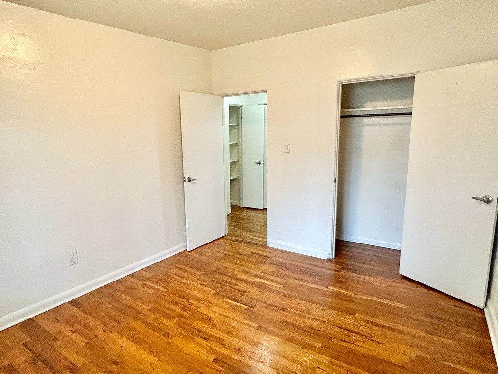 A room with wooden floors and white walls.