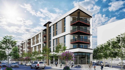 A modern apartment building with balconies and a parking lot in front.