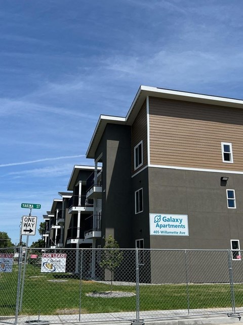 A building with a sign that says "Galaxy Apartments" is shown.
