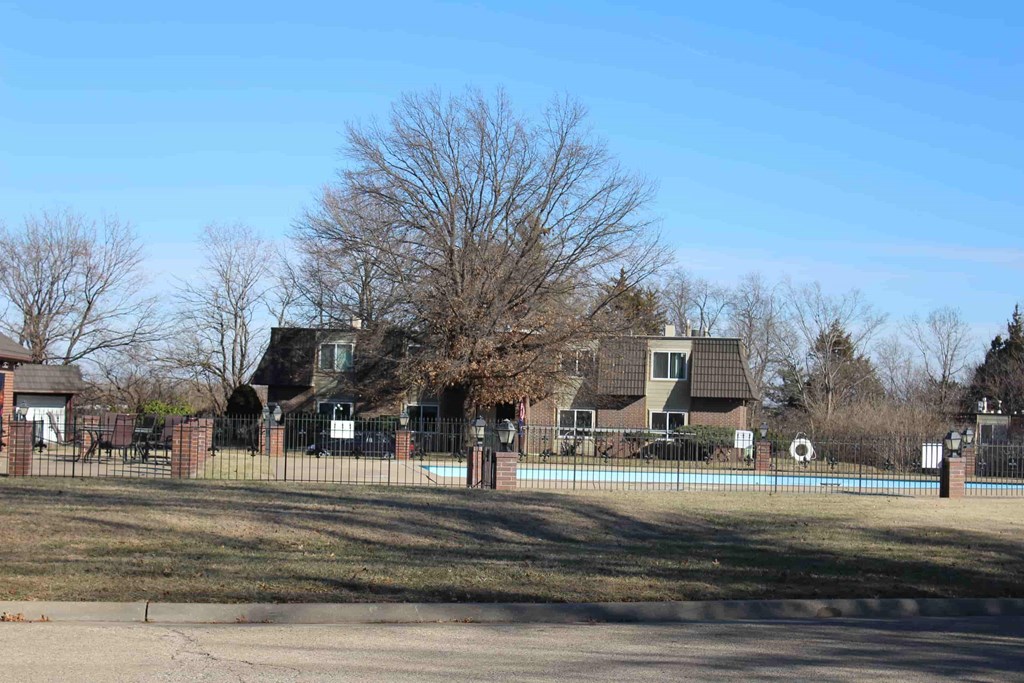 A residential area with a pool and a fence.