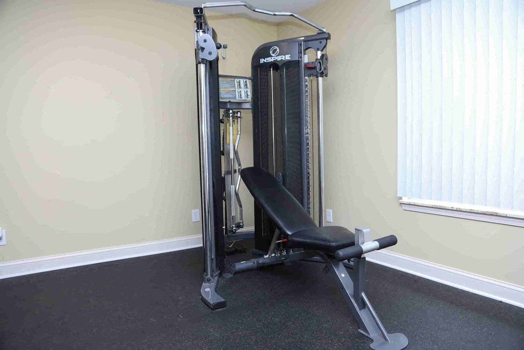 A gym machine is in a room with a window.