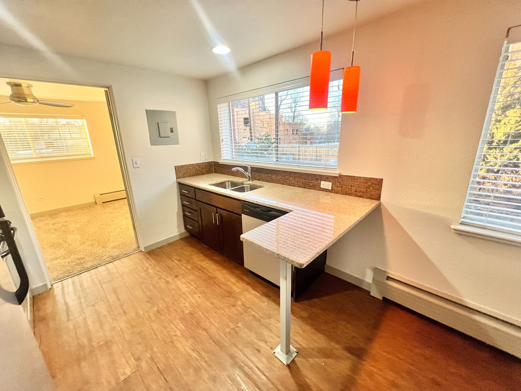 A staircase with a tiled floor and a wooden handrail.