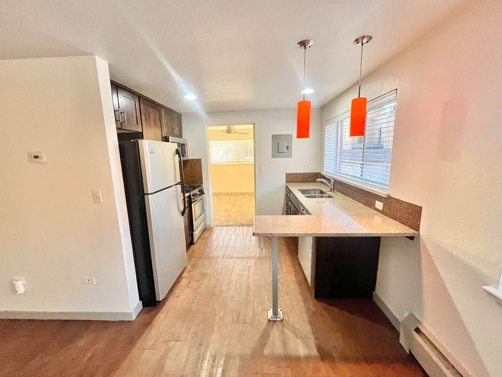A staircase with a black railing and a brown carpeted runner.