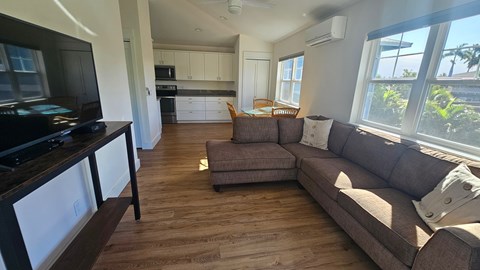 A living room with a couch and a television.