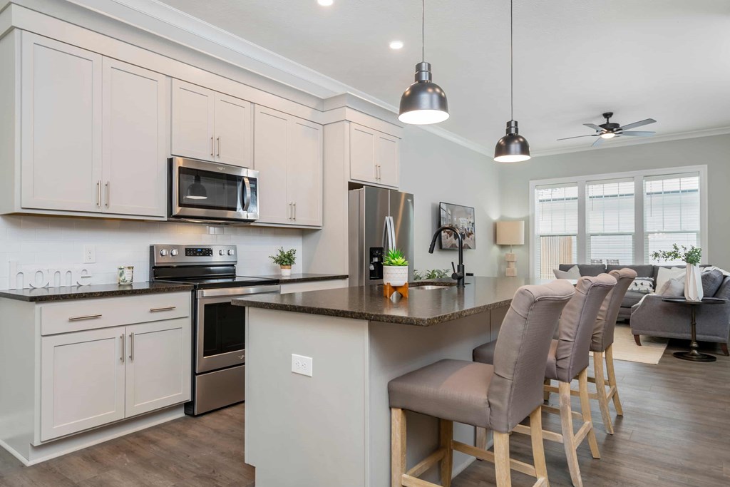 A kitchen with a bar area and a dining table.