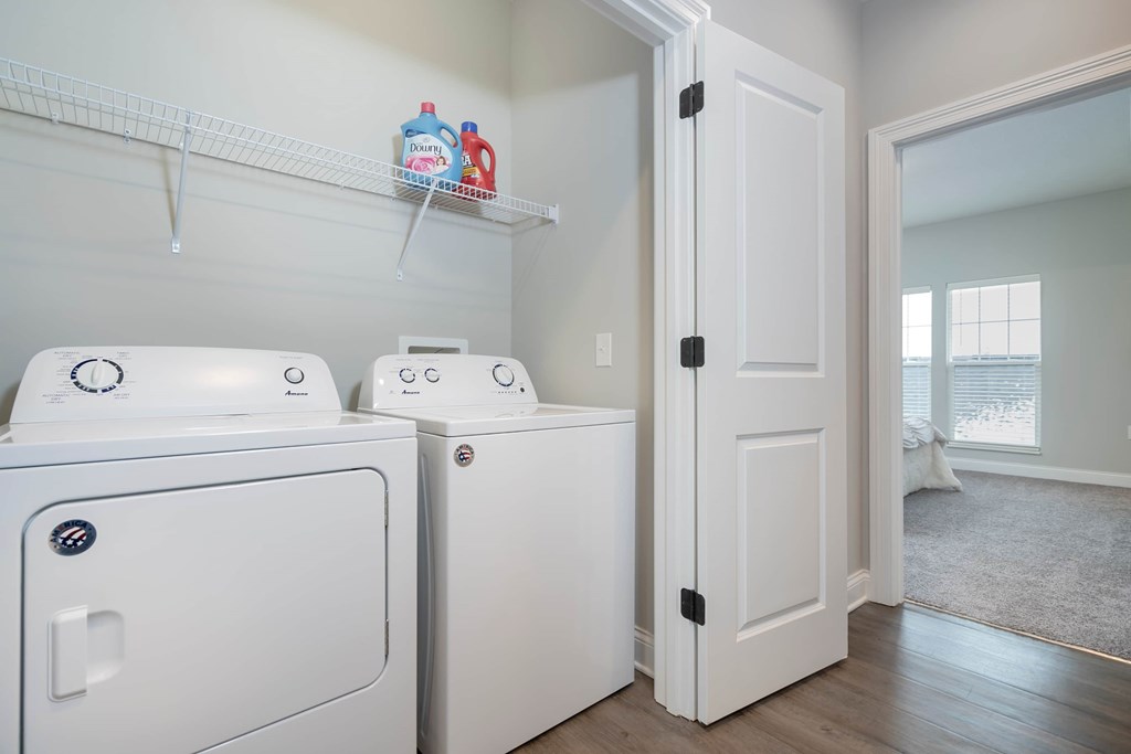A white washing machine and dryer in a laundry room.