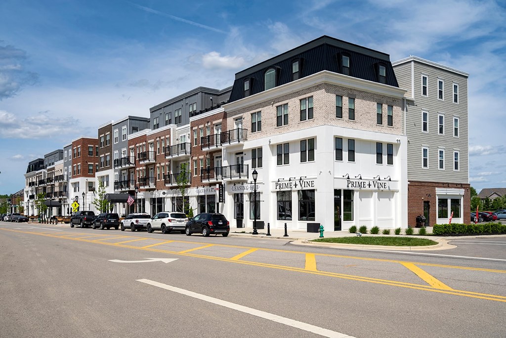 A street view of a row of buildings with the name