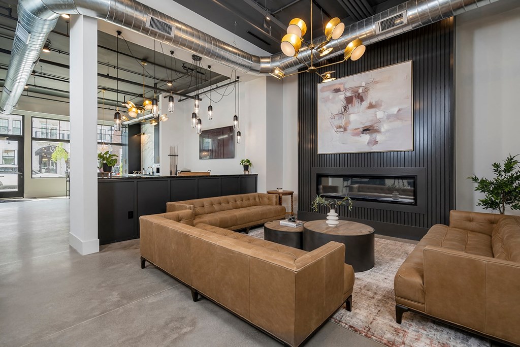 A modern living room with a fireplace and a large painting on the wall.