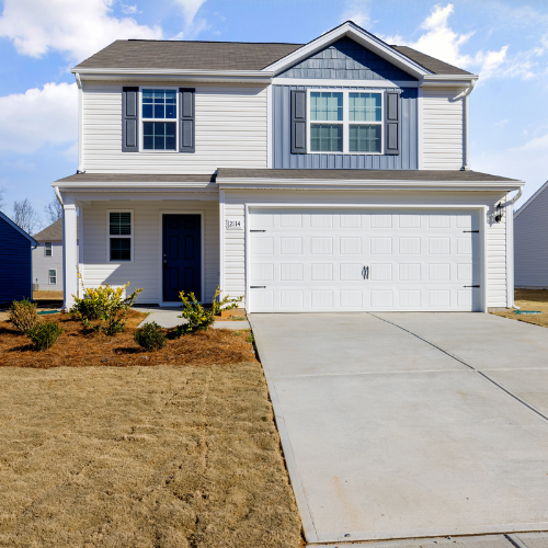 A two-story house with a garage and a driveway.