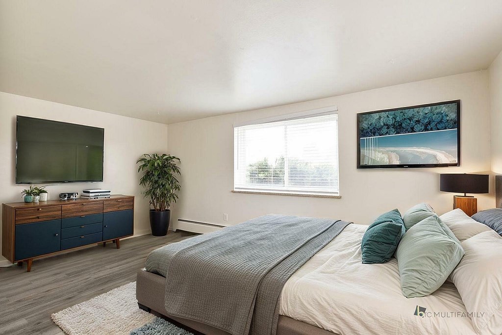 A kitchen with a black fridge and a sink.
