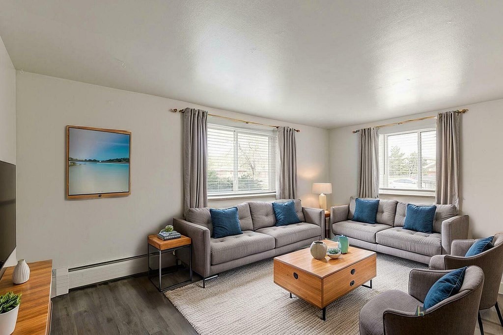 A bathroom with a glass shower stall, toilet, and sink.