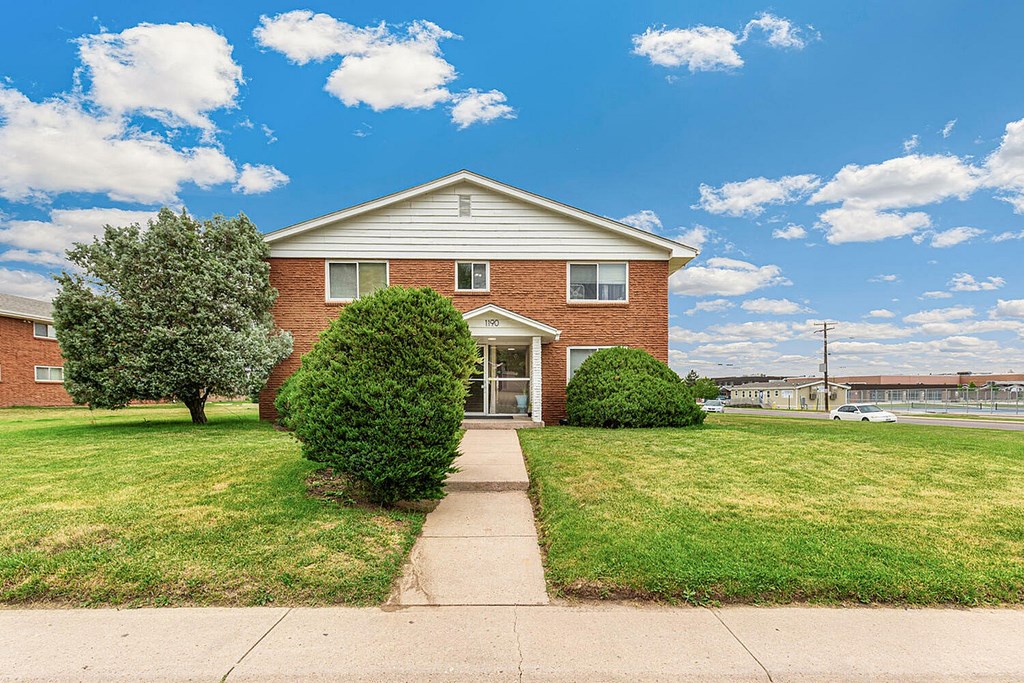 A house with a tree in front of it.