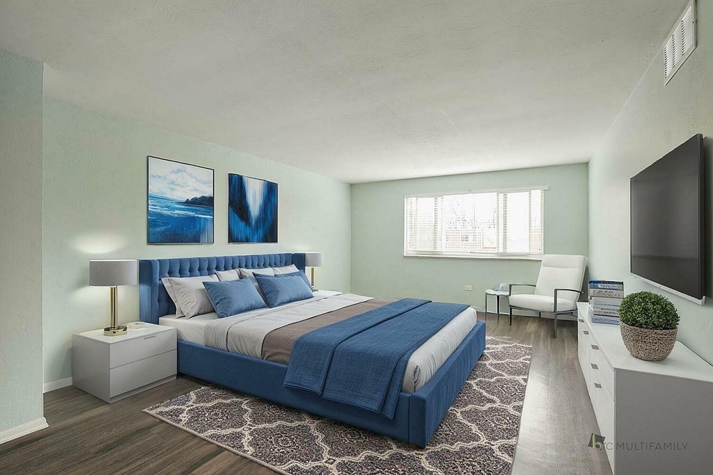 A bedroom with a large bed and a painting on the wall.