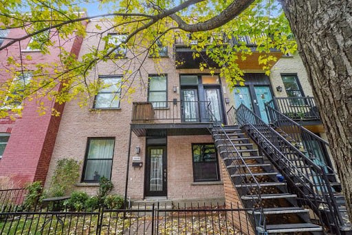 A multi-story building with a black metal staircase.