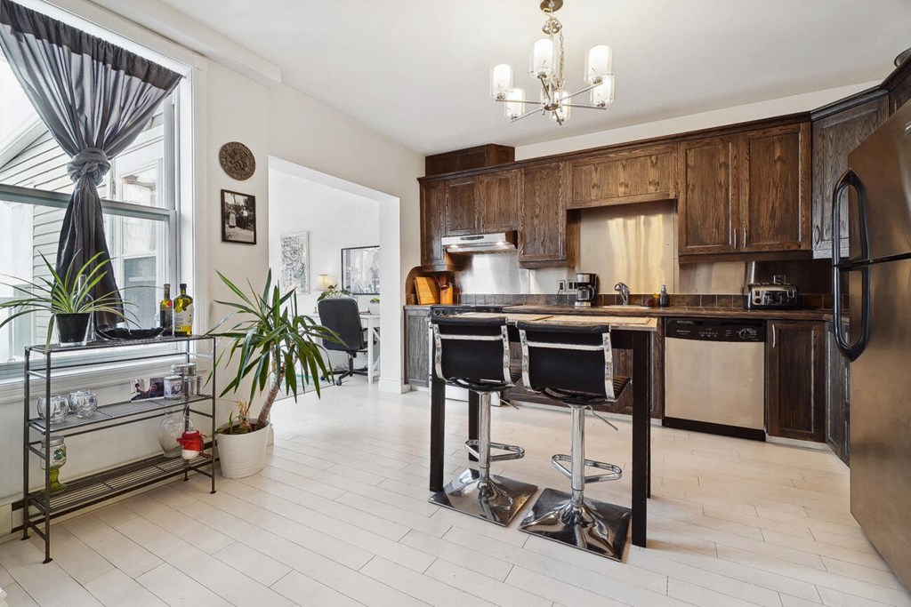 A kitchen with a black and white color scheme.