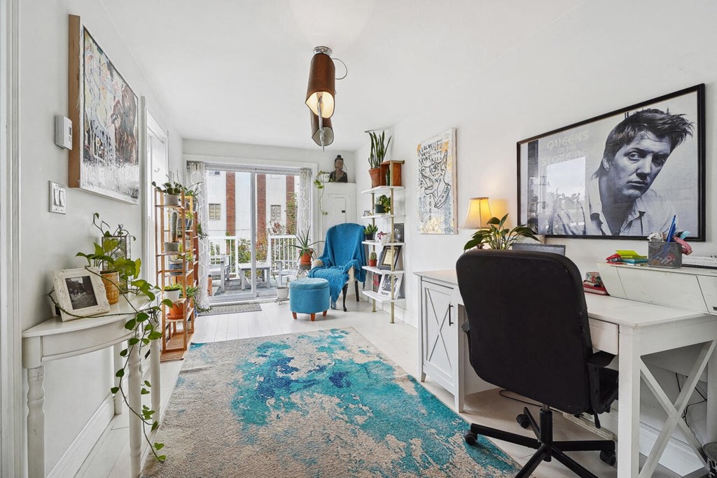 A room with a desk and a chair.