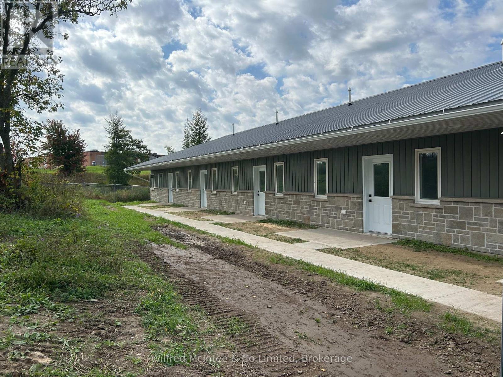 A row of houses with white doors and windows.
