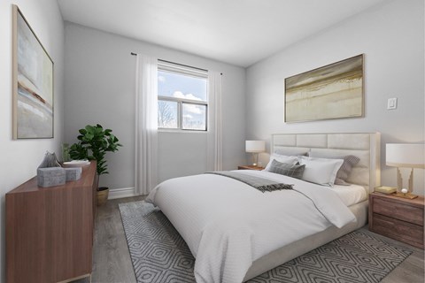 A bedroom with a large bed, a nightstand, and a plant.