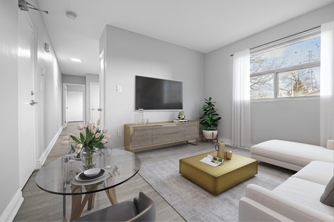 A modern living room with a glass table and a white sofa.
