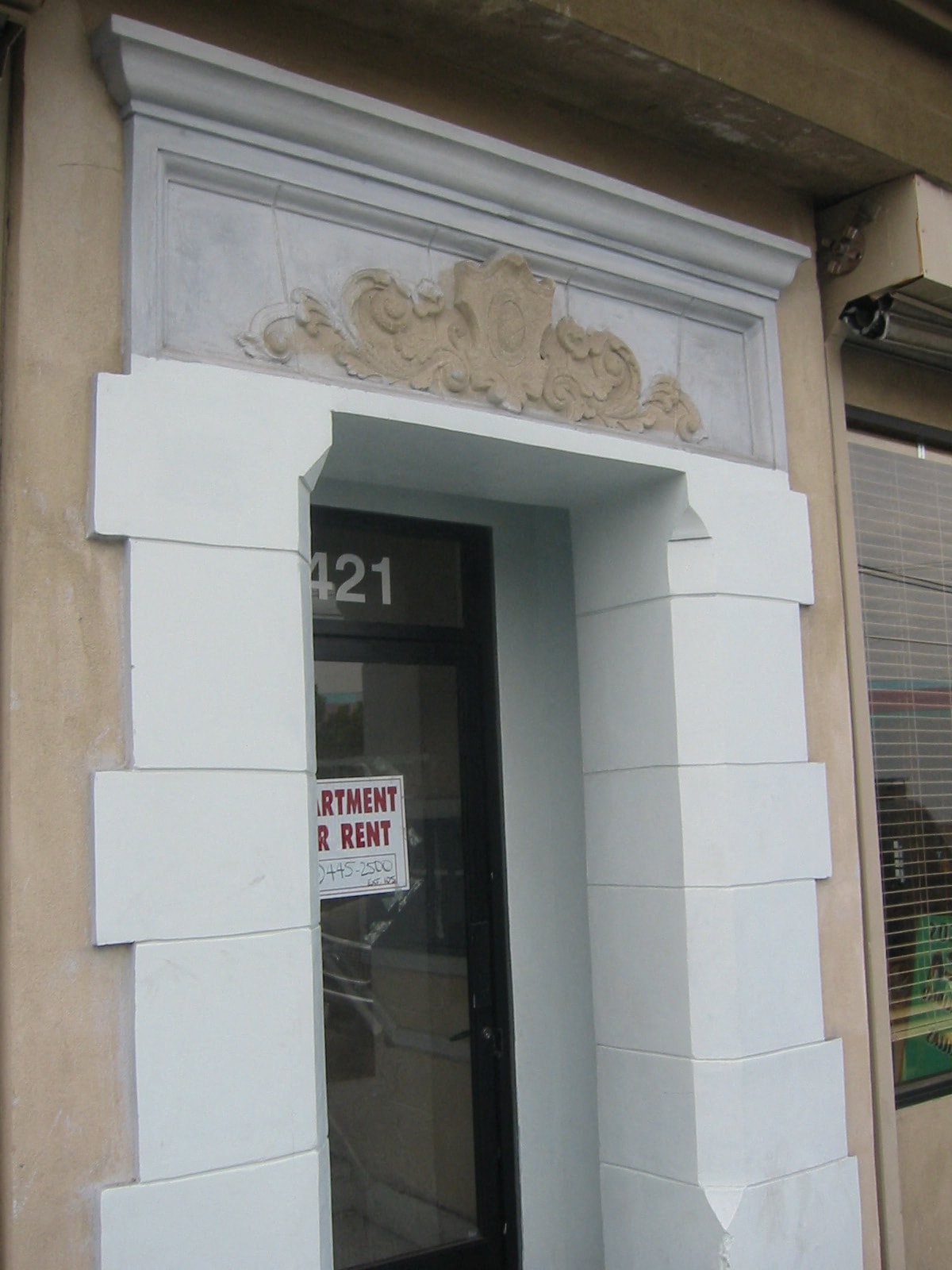 A window with a sign that says "Rent".