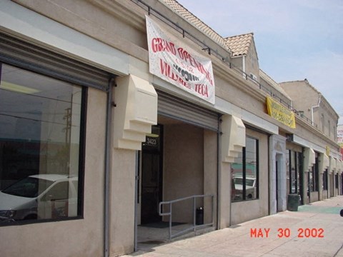 A building with a sign that says Grand Opening on it.