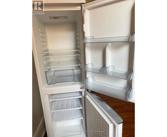 A white refrigerator with the door open and shelves inside.