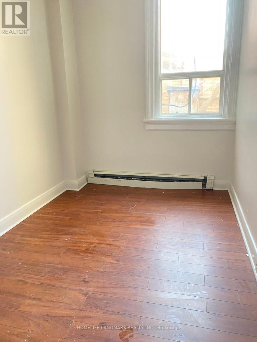 A room with a window and a radiator on the floor.