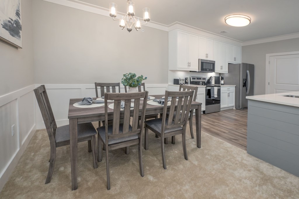A dining room with a table set for six.