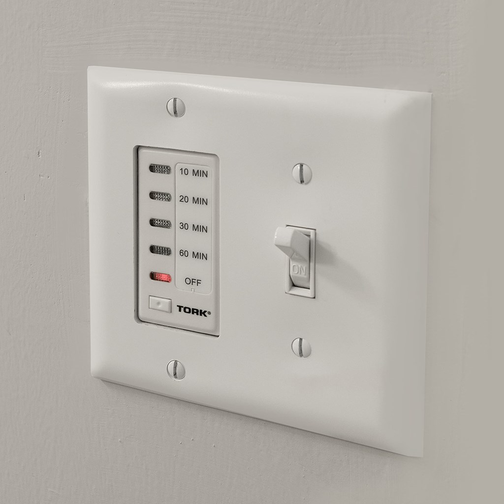 A white Tork timer switch with settings of 10, 20, 30, and 60 minutes.