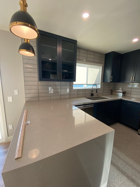 A kitchen with a countertop and black cabinets.