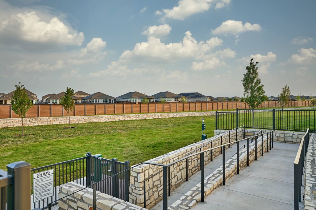 A view of a park with a fence and a sign that says "Joe's Walk".