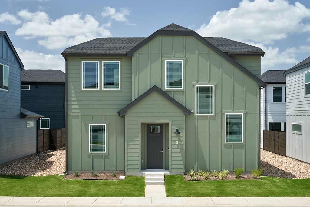 A house with a grey front and a black door.