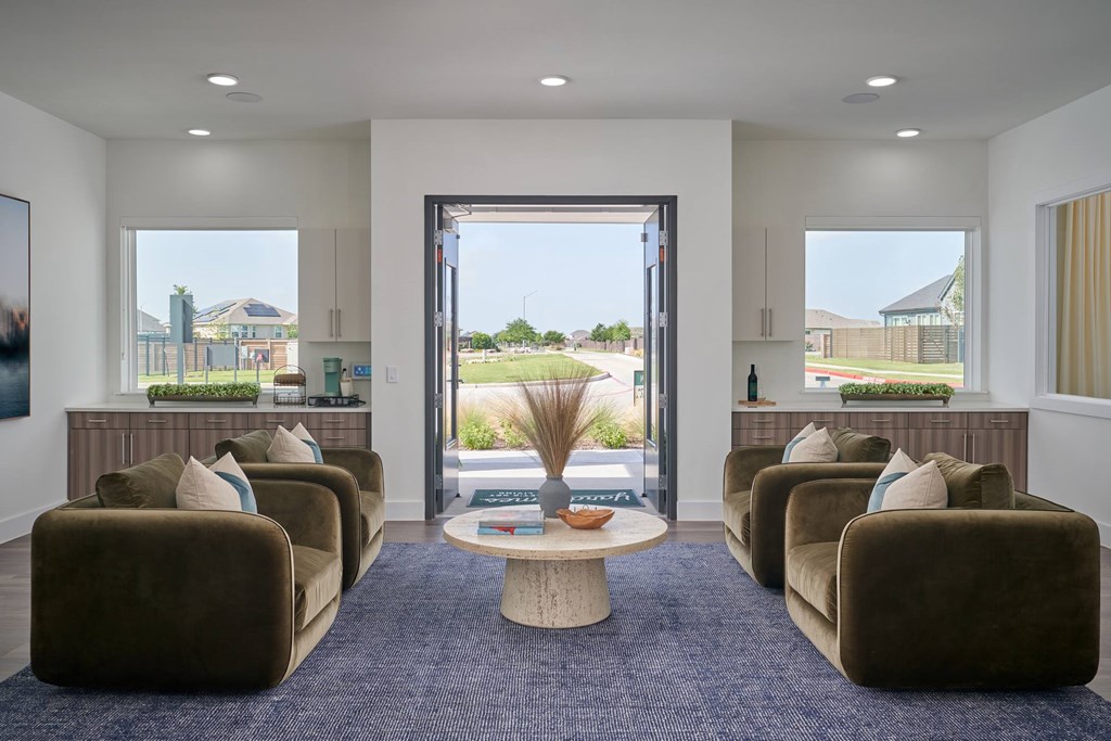 A living room with brown couches and a large window.