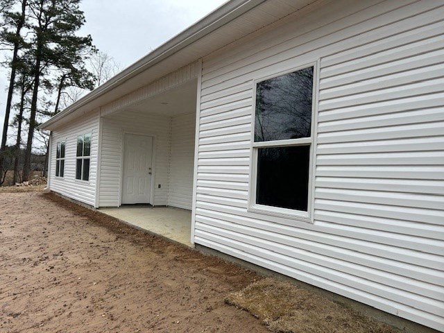 A white house with a brown door and windows.