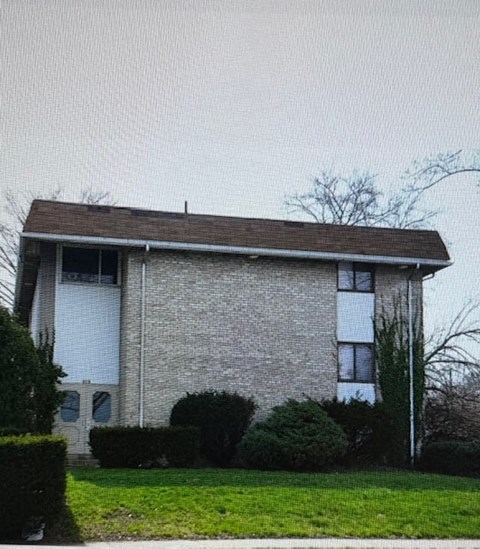 A house with a brown roof and a white garage door.