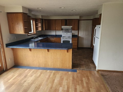 A kitchen with wooden cabinets and a blue countertop.
