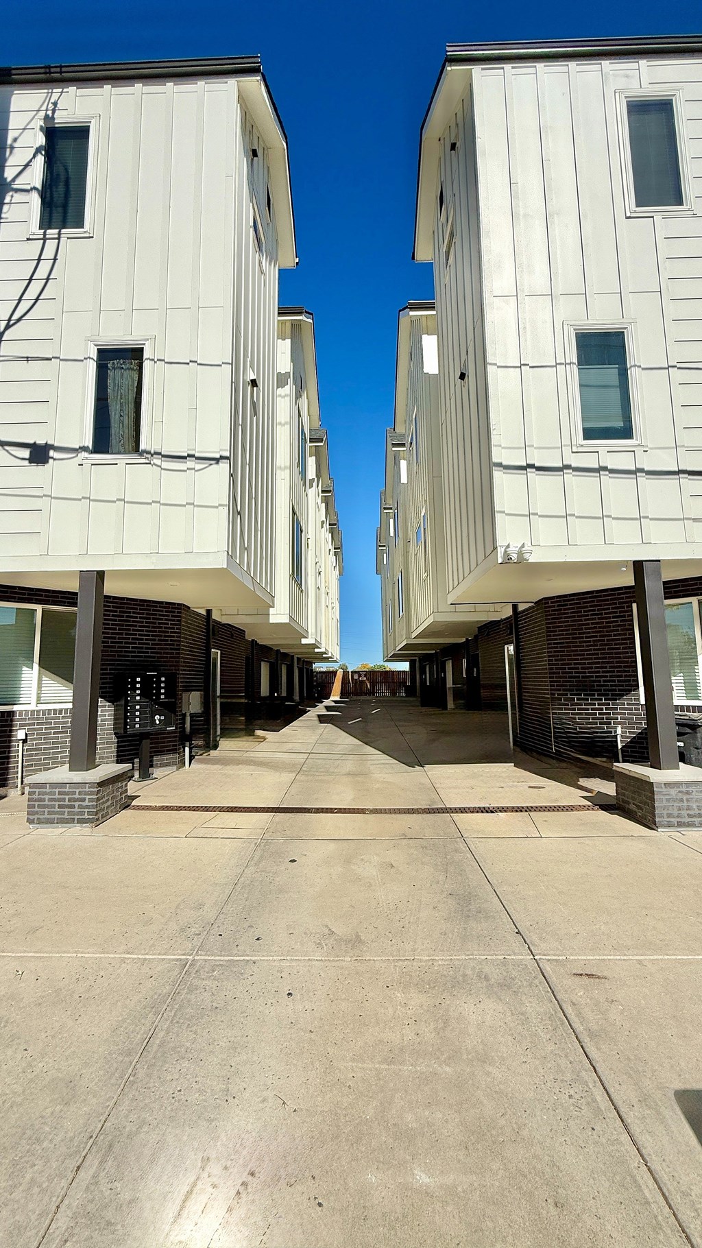 A bathroom with a sink, mirror, and a painting on the wall.