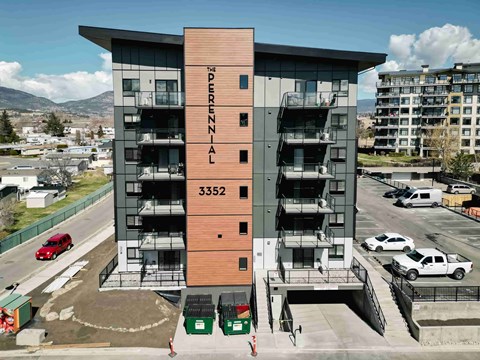 The Perdonnaal building is a modern multi-story structure with a parking lot in front.