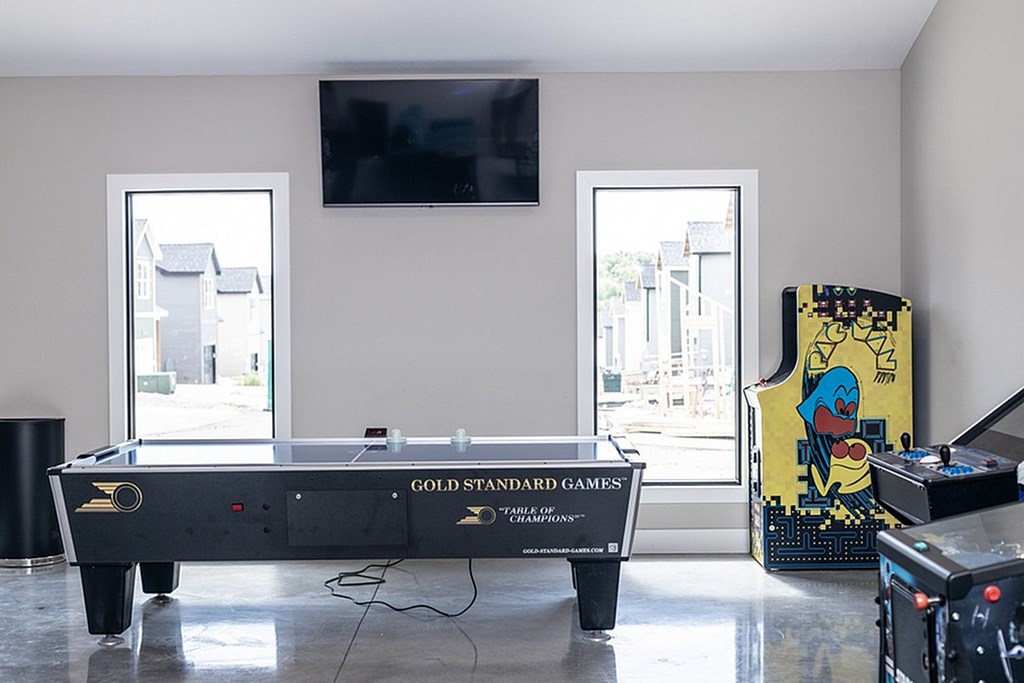 A park area with a playground and a basketball court in a residential area.