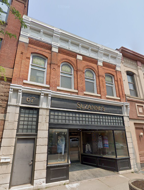 A brick building with a storefront called Suzanne's.