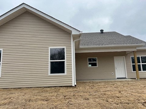 A house with a brown roof and a white door.