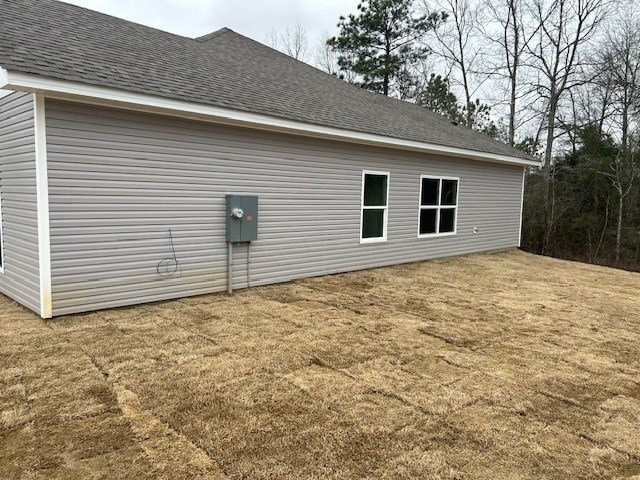 A grey building with a grey roof and a grey garage door.