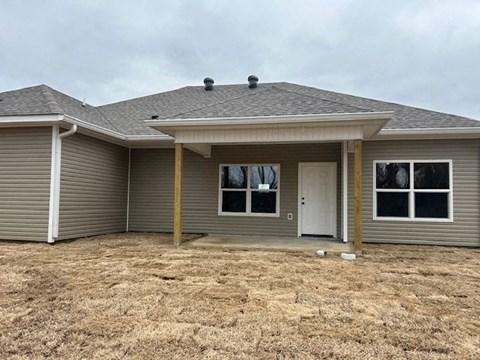 A house with a grey roof and a white door.