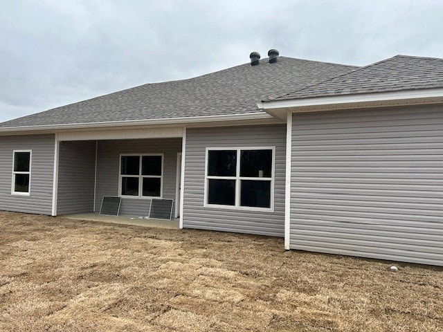 A grey house with a grey roof and grey siding.