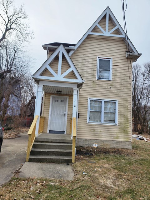 A small house with a white door and a window.